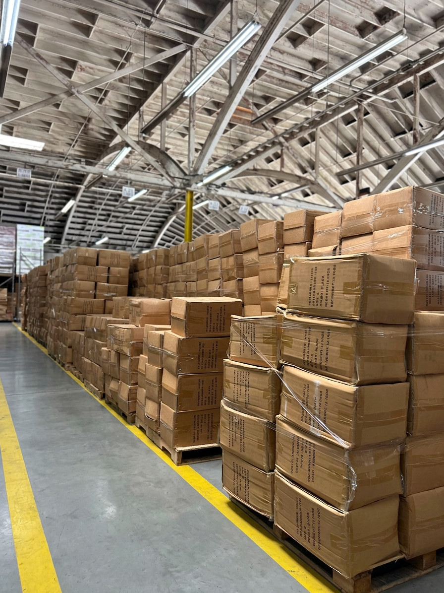 Endless rows of palletized cartons under bow-truss ceiling at Logix Fulfillment Vernon CA warehouse