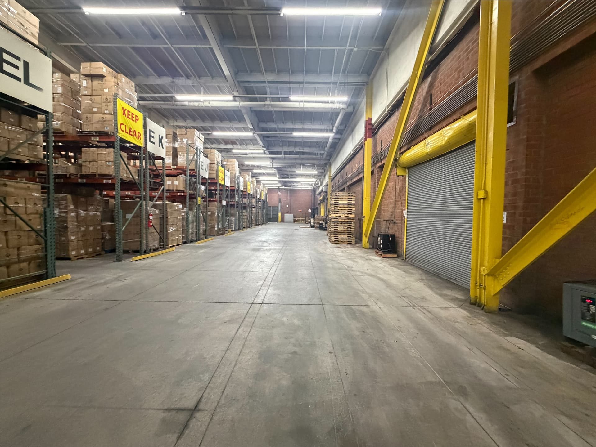Long racking aisle with yellow dock doors at Logix Fulfillment in Vernon, CA